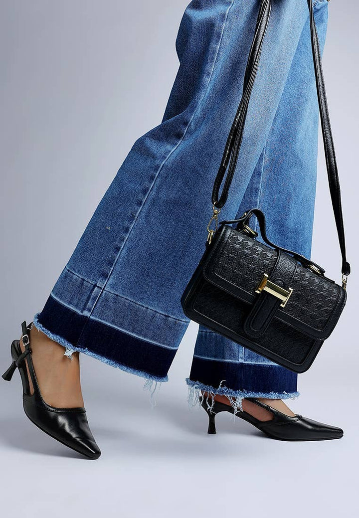 A Styled Collective black faux leather kitten heel slingbacks with snip toe and buckle strap worn with denim jeans