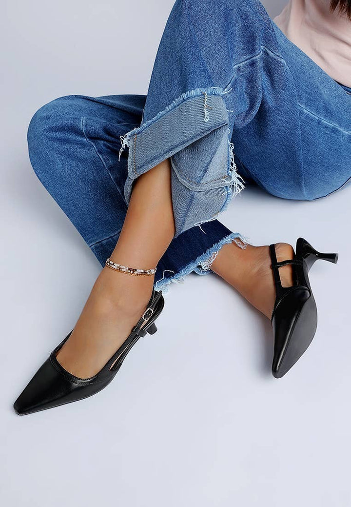 A Styled Collective black faux leather kitten heel slingbacks with a snip toe and adjustable buckle strap.