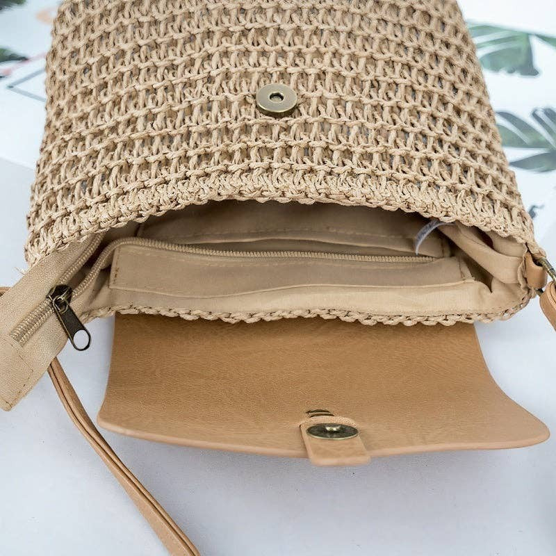 A Styled Collective beige woven straw crossbody bag with a magnetic flap closure and interior zipper pocket.