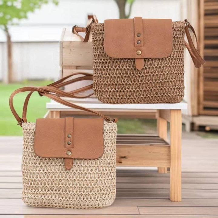 A Styled Collective straw crossbody bags with tan leather flaps and adjustable straps on a wooden outdoor table.